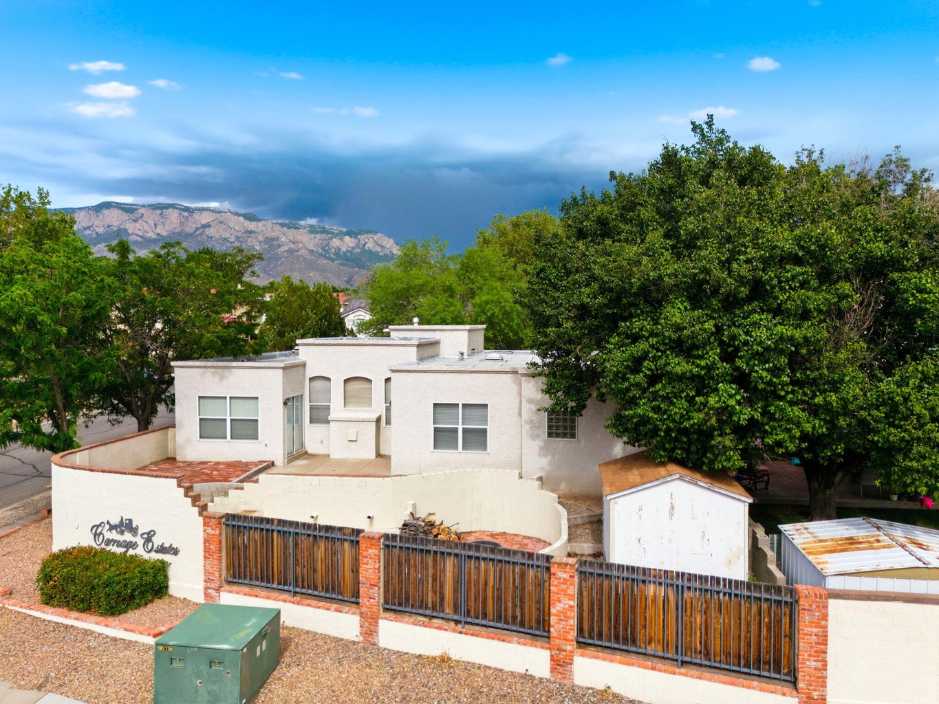 Aerial view of 7415 Coachman Street NE in Albuquerque, showing the property setting, roofline, and surrounding Northeast Albuquerque area.