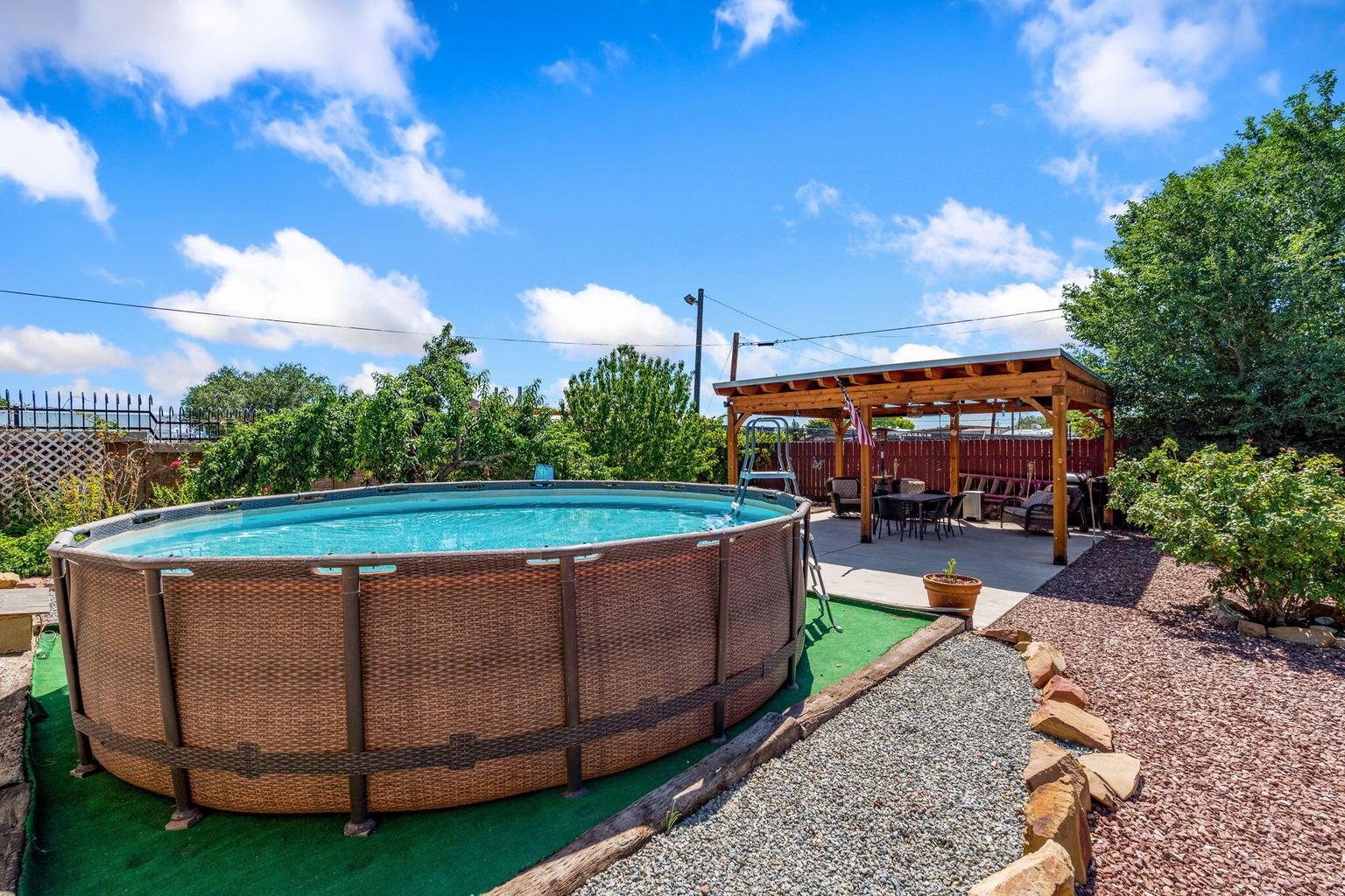 Backyard at 4411 Carlton Street NW in Albuquerque, showing an above-ground pool area mentioned in the listing materials.