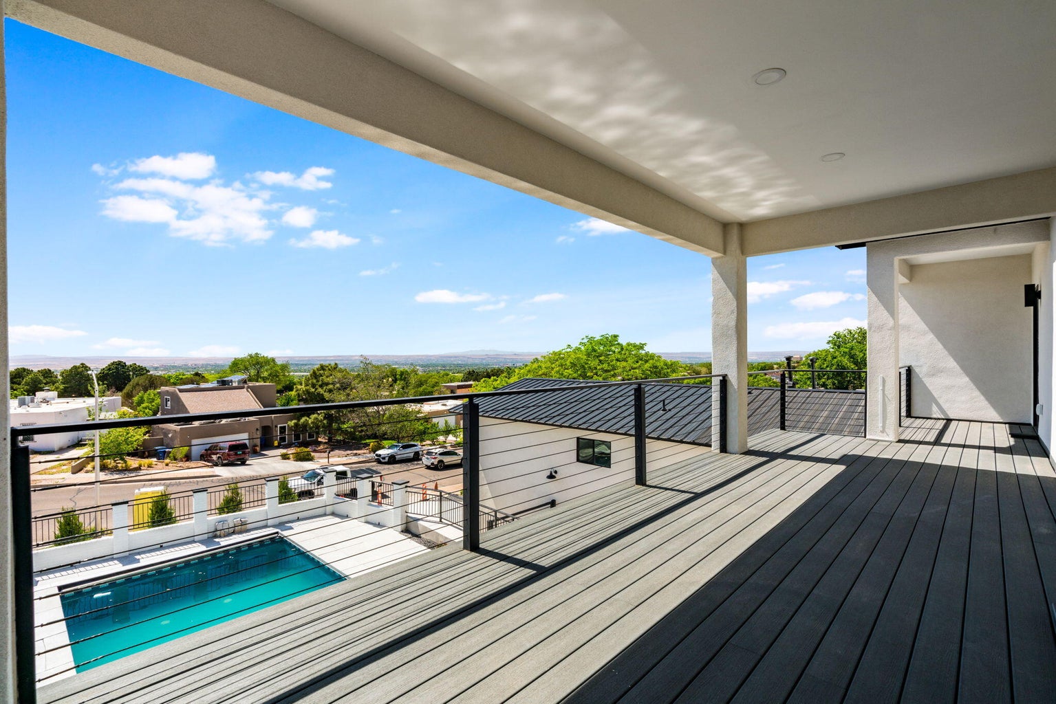 View from the balcony at 1136 Turner Drive NE in Albuquerque, showing west-facing city and sunset-view context from the outdoor living area.
