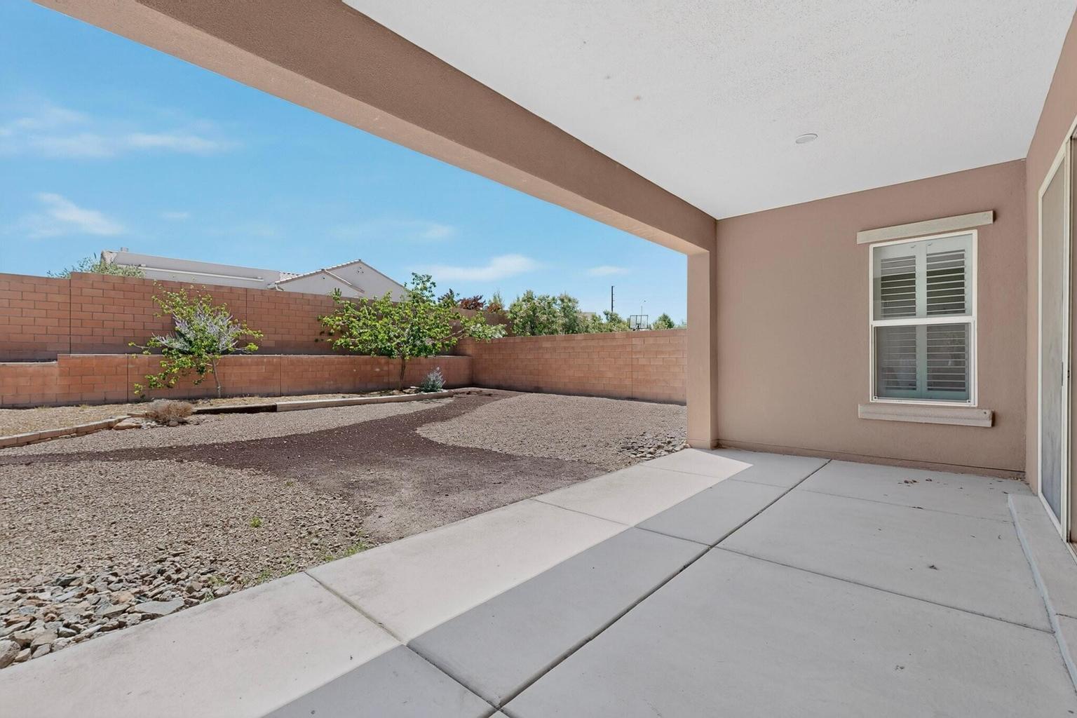 Backyard at 4707 Lluvia Encantada in Santa Fe, showing outdoor space with room for seating, landscaping, and backyard use.