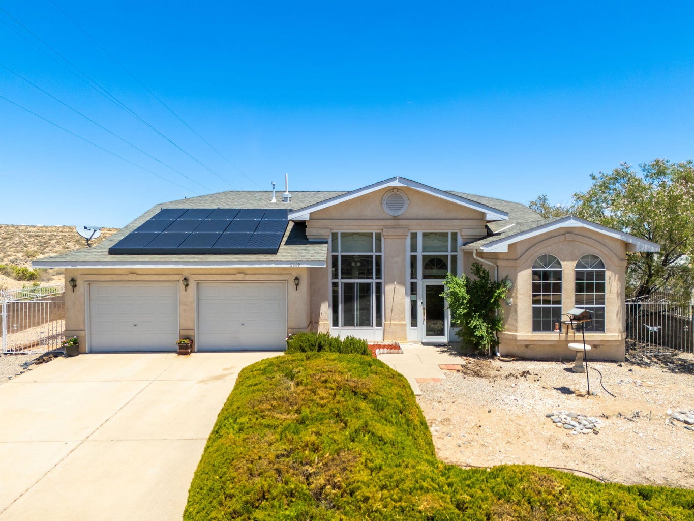 Front exterior of 2869 Chessman Drive SE in Rio Rancho, NM, showing the single-story detached home and attached garage.