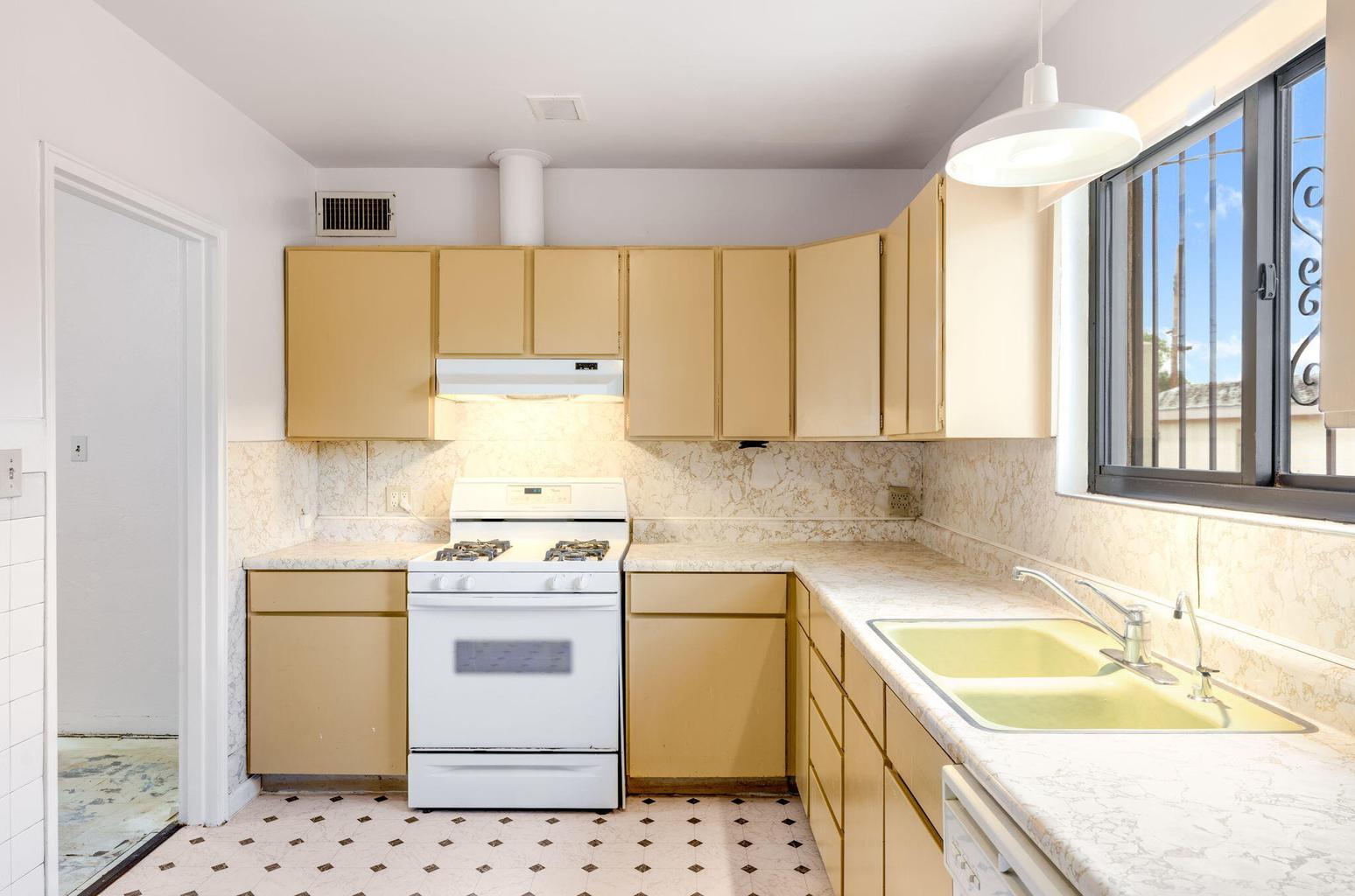 Kitchen at 2721 Bel Air Drive NE in Albuquerque, showing the cabinetry, counters, sink area, and appliance spaces.