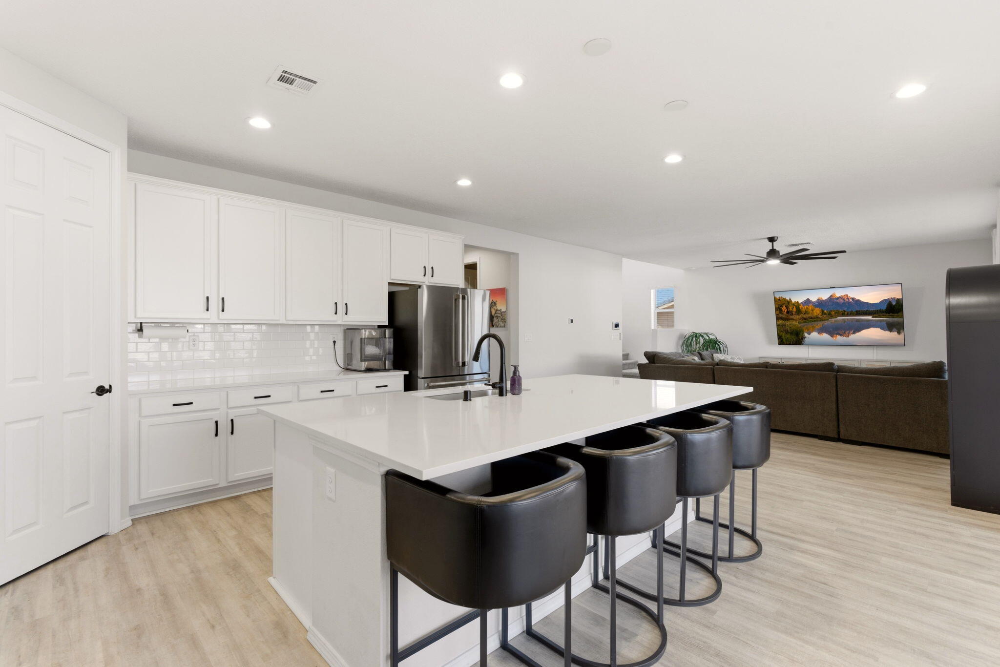 Kitchen and dining area at 3206 Martuni Street SE in Rio Rancho, showing the oversized island, quartz countertops, and open dining connection.