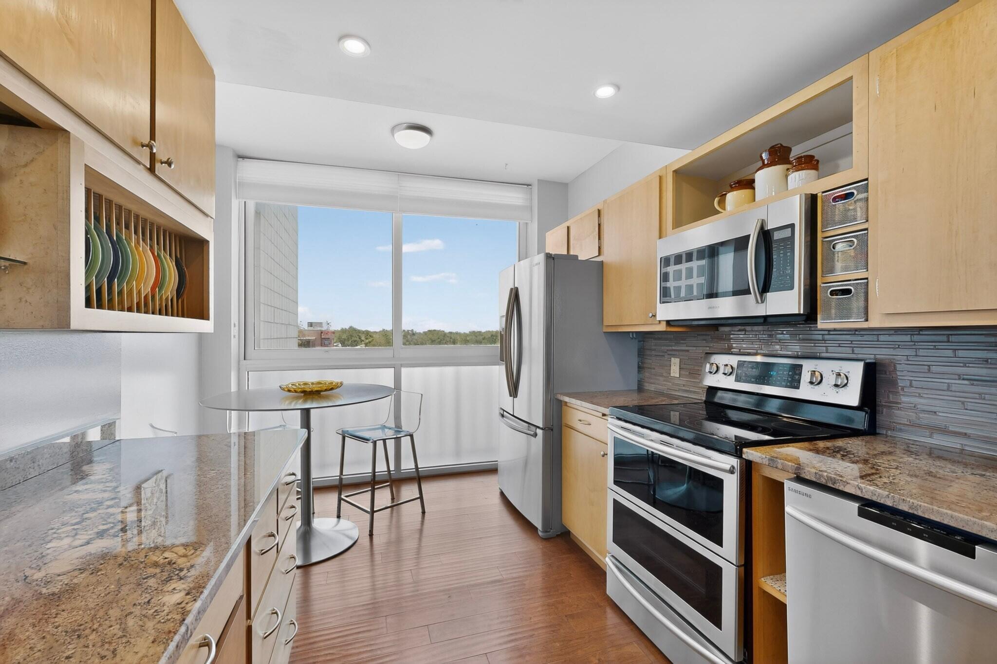 Kitchen at 600 Alcalde Place SW 5A in Albuquerque, showing granite countertops, stainless steel appliances, and an updated condo kitchen layout.