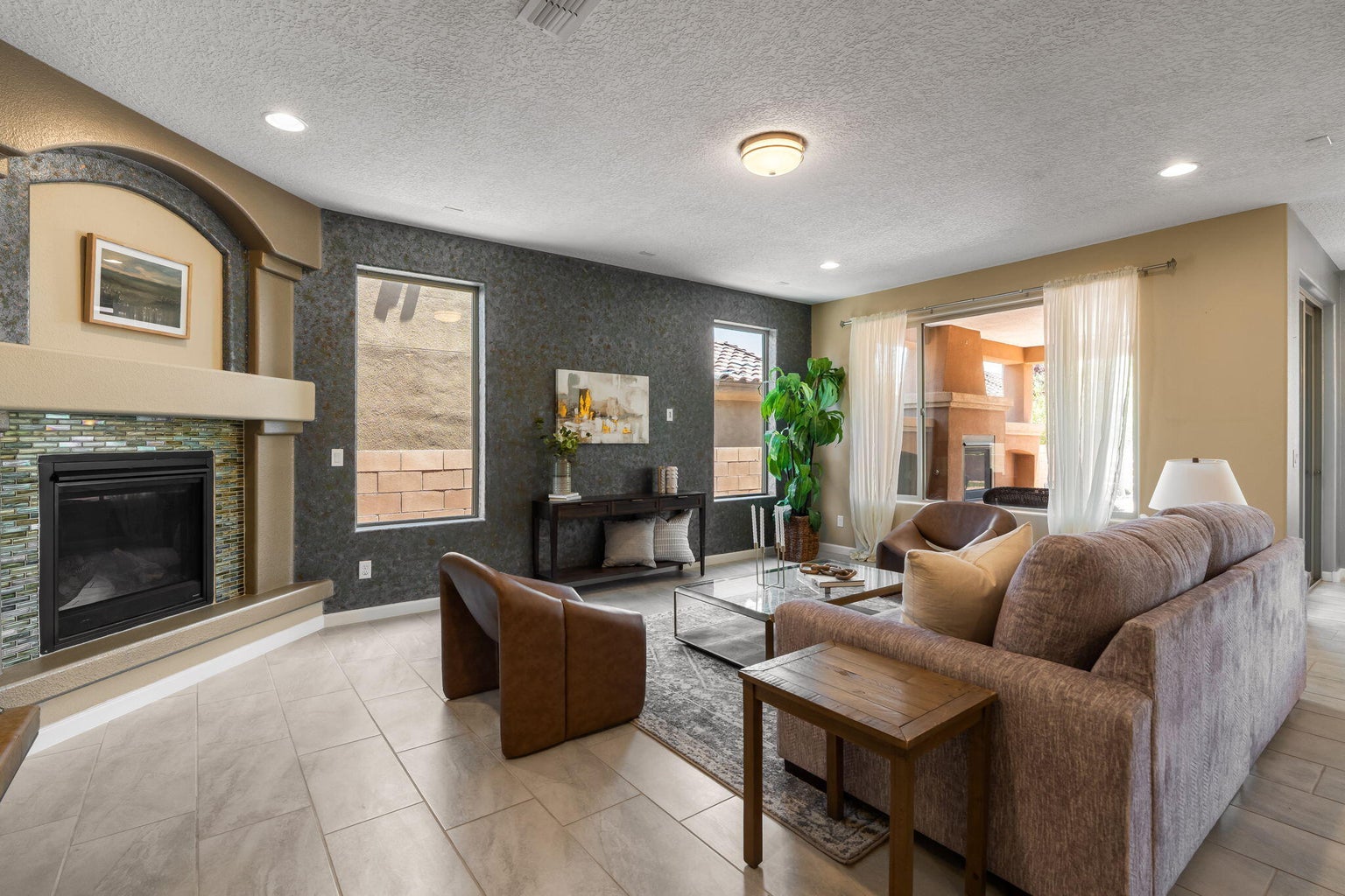 Living room at 9228 Sugar Creek Lane NW in Albuquerque, showing a fireplace and open interior living space.