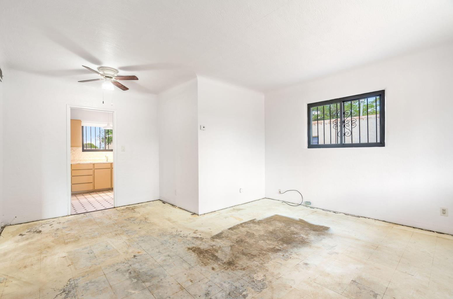 Living room at 2721 Bel Air Drive NE in Albuquerque, showing an unfinished floor surface and open space ready for a new design direction.