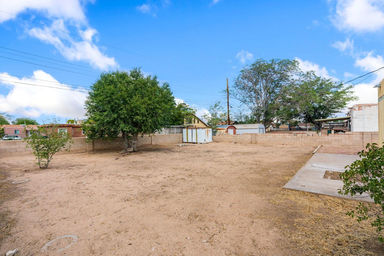Backyard at 2721 Bel Air Drive NE in Albuquerque, showing the broad open yard area behind the single-level home.