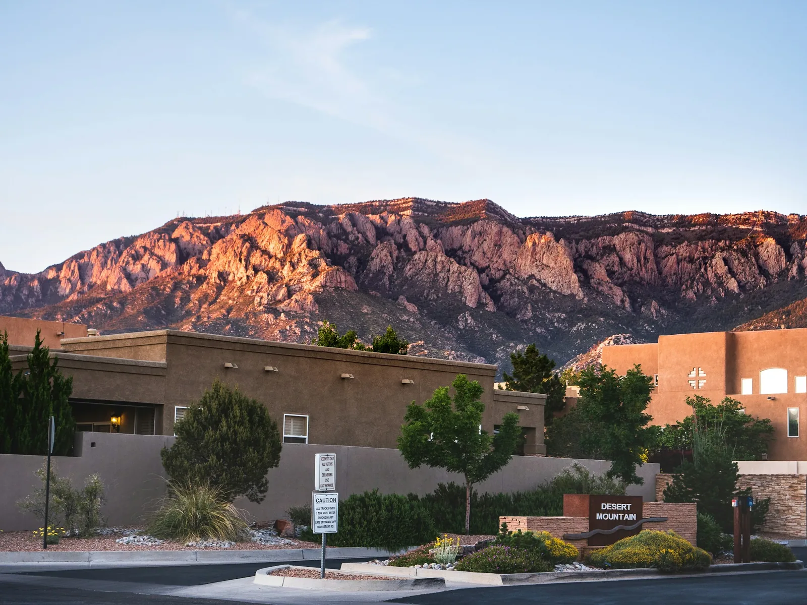 Albuquerque homes below the Sandia Mountains in evening light.