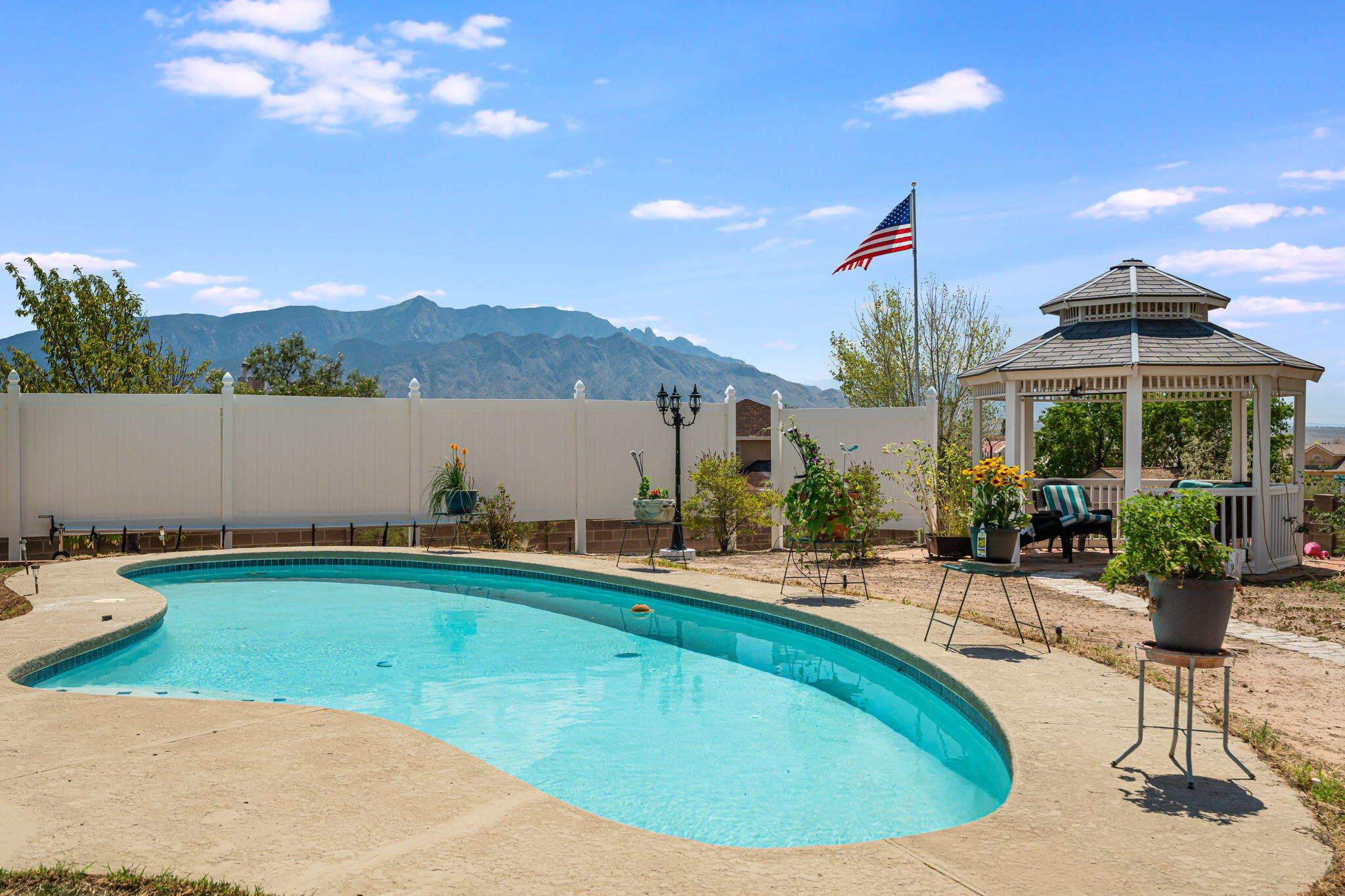 In-ground pool, gazebo and mountain view at 7250 Pelona Court NE in Rio Rancho