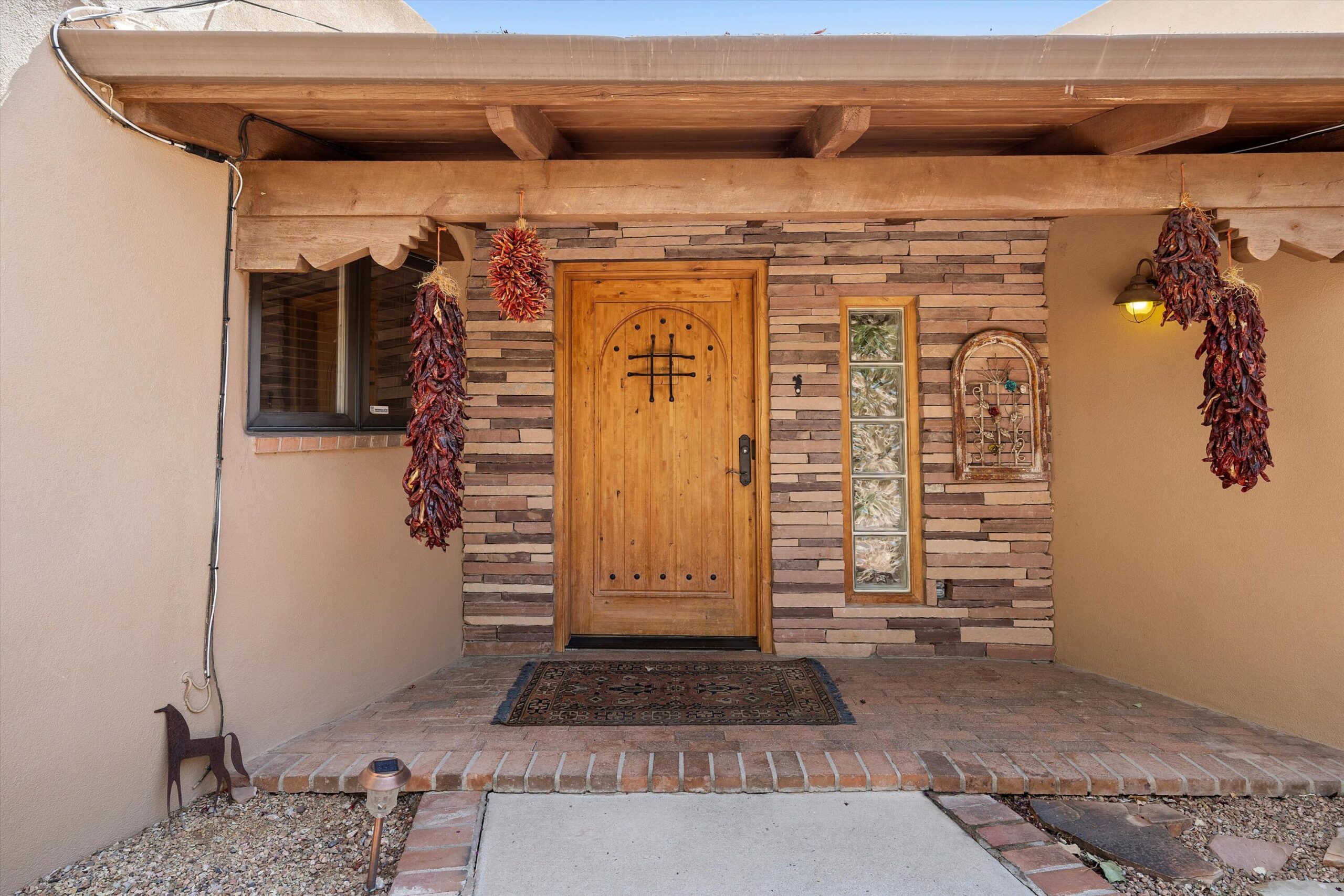 Detailed wood entry of the Pueblo-style home at 4068 Dietz Farm Circle NW in Los Ranchos