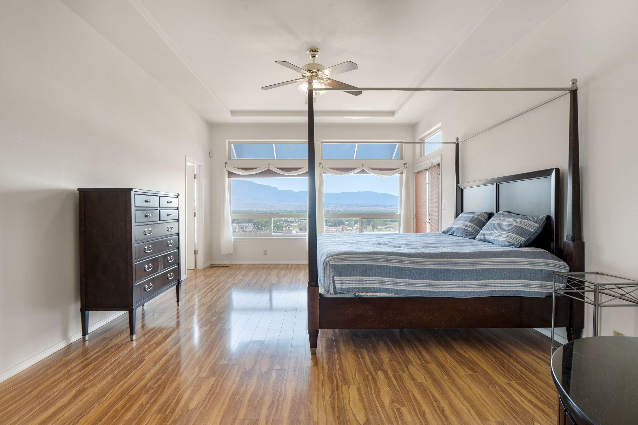Primary bedroom at 40 Sereno Road with wood floors and a broad window framing the distant mountains