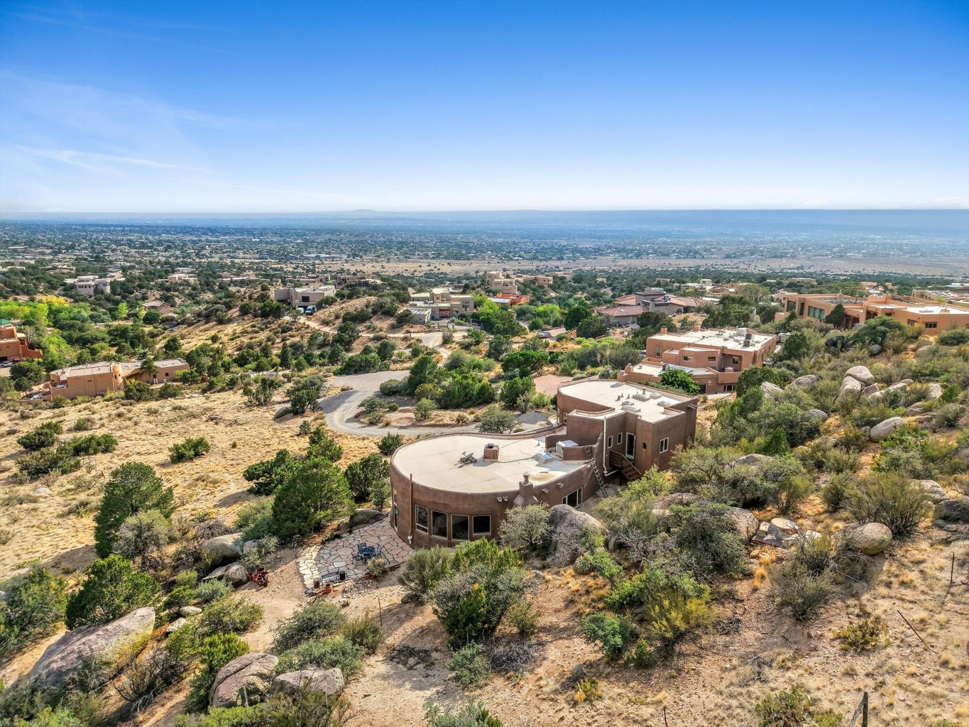 Aerial view of 303 Spring Creek Place NE with Albuquerque stretching across the western horizon