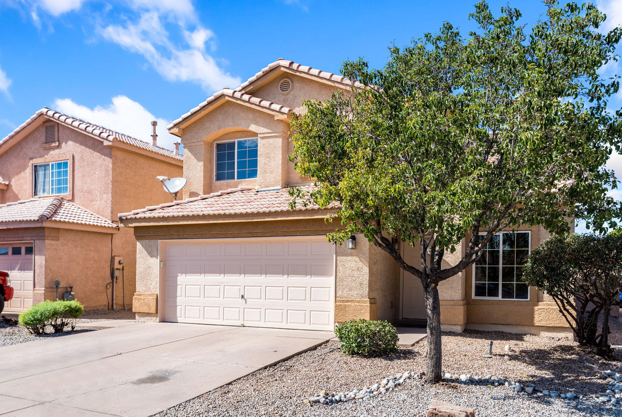 Two-story stucco exterior with tile roof and attached garage at 7615 Via Cometa SW.