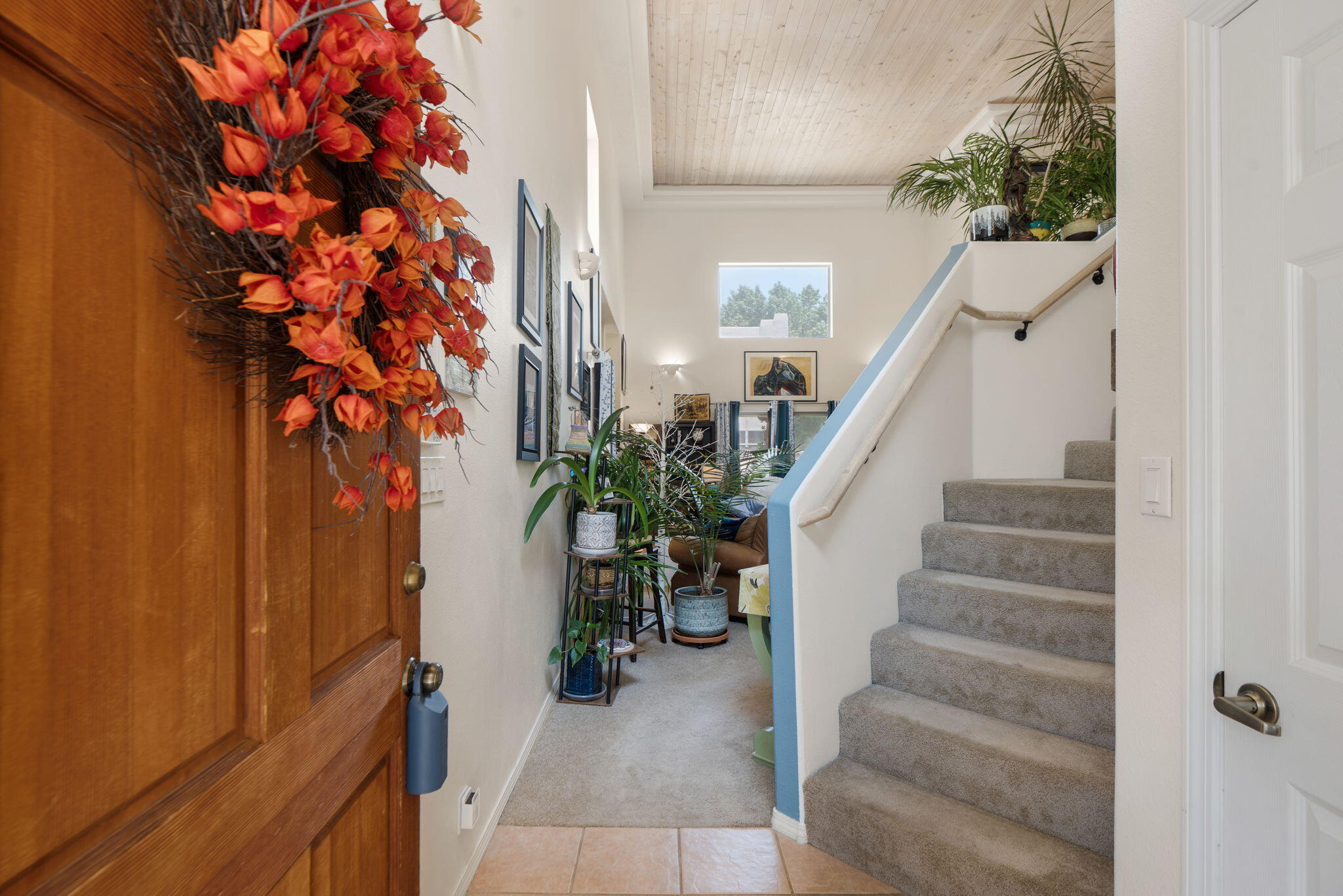 Living room with fireplace, high ceiling, and blue accent wall at 3601 Calle Oveja Court NW