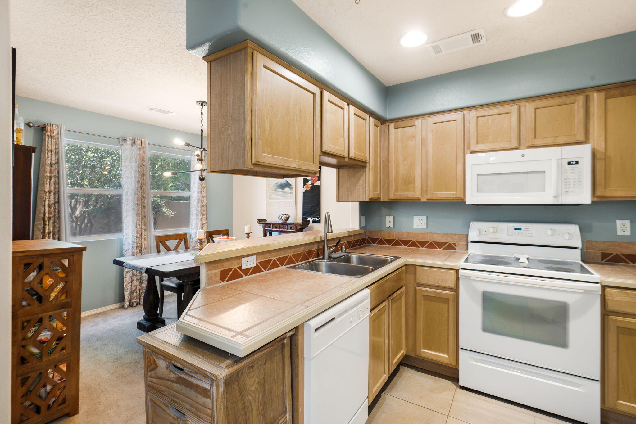 Dining area opening to the kitchen at 3601 Calle Oveja Court NW