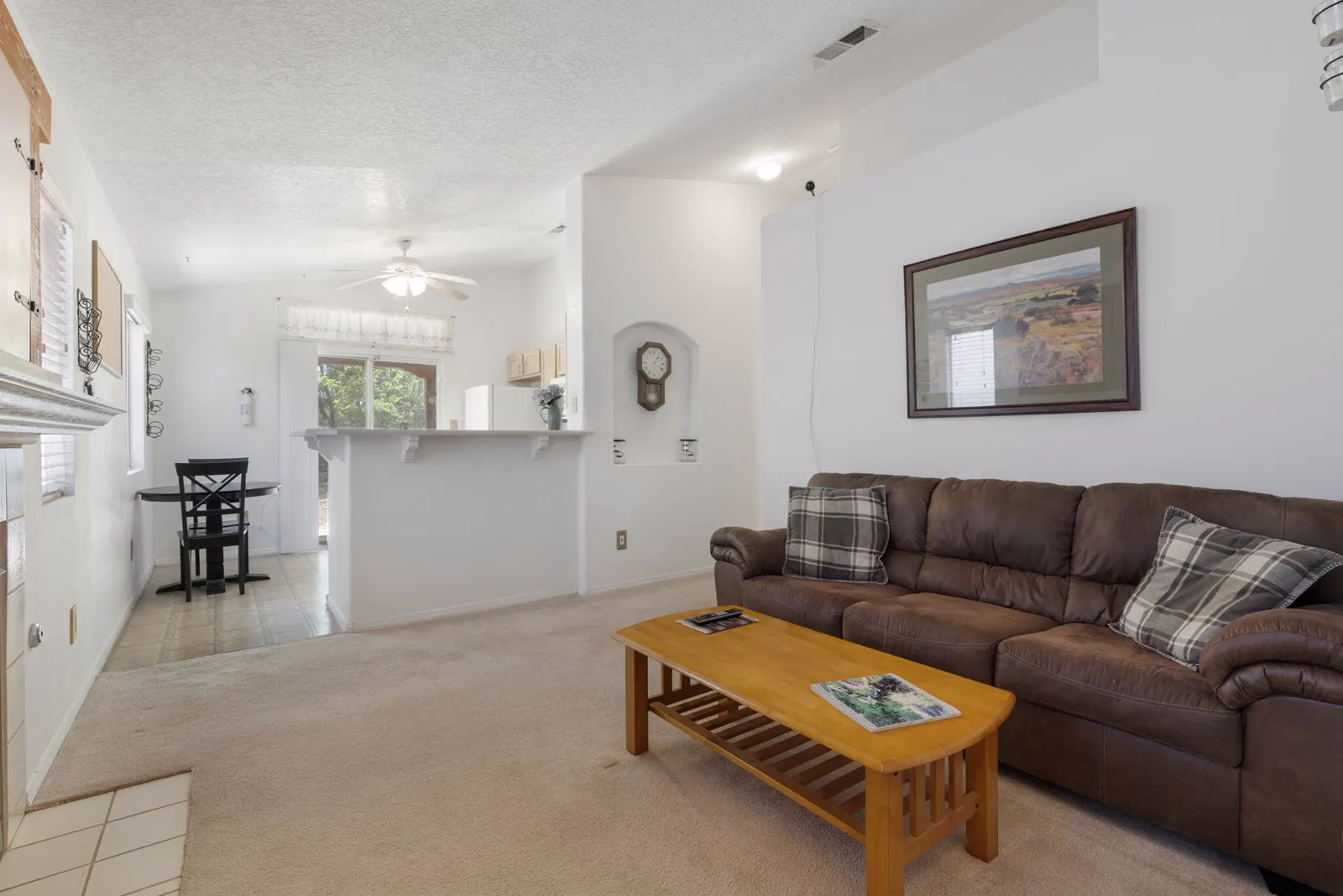 Living area connected to the kitchen and breakfast space inside the single-level home at 6004 Cyonus Avenue NW