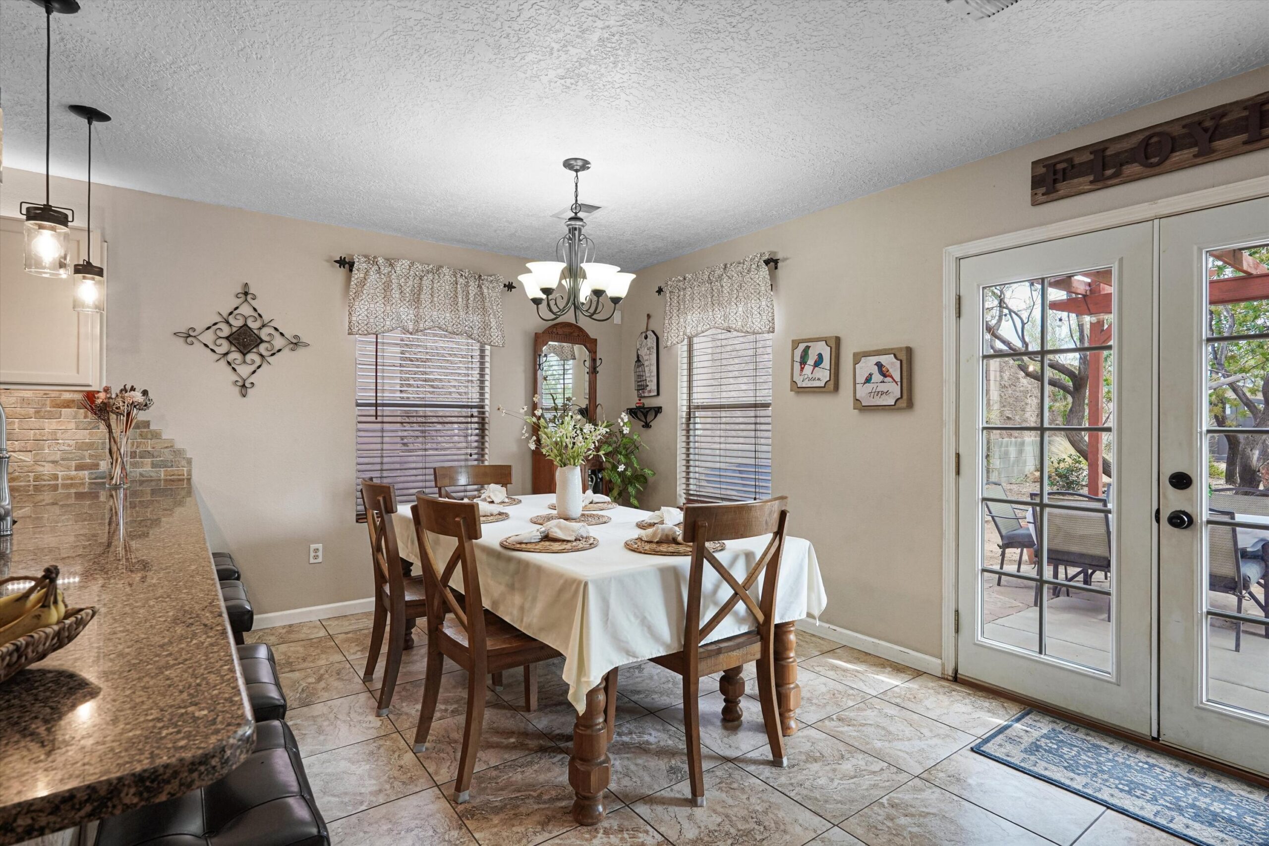 Dining area beside French doors leading to the covered patio