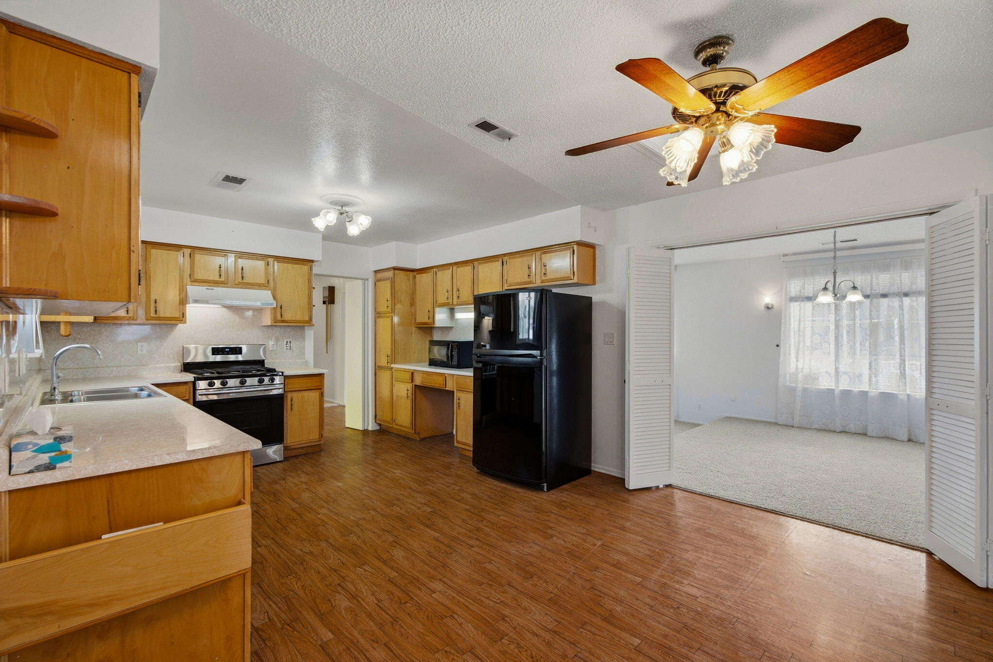 Kitchen with wood cabinetry and adjoining dining area at 4108 Leon Grande Avenue SE