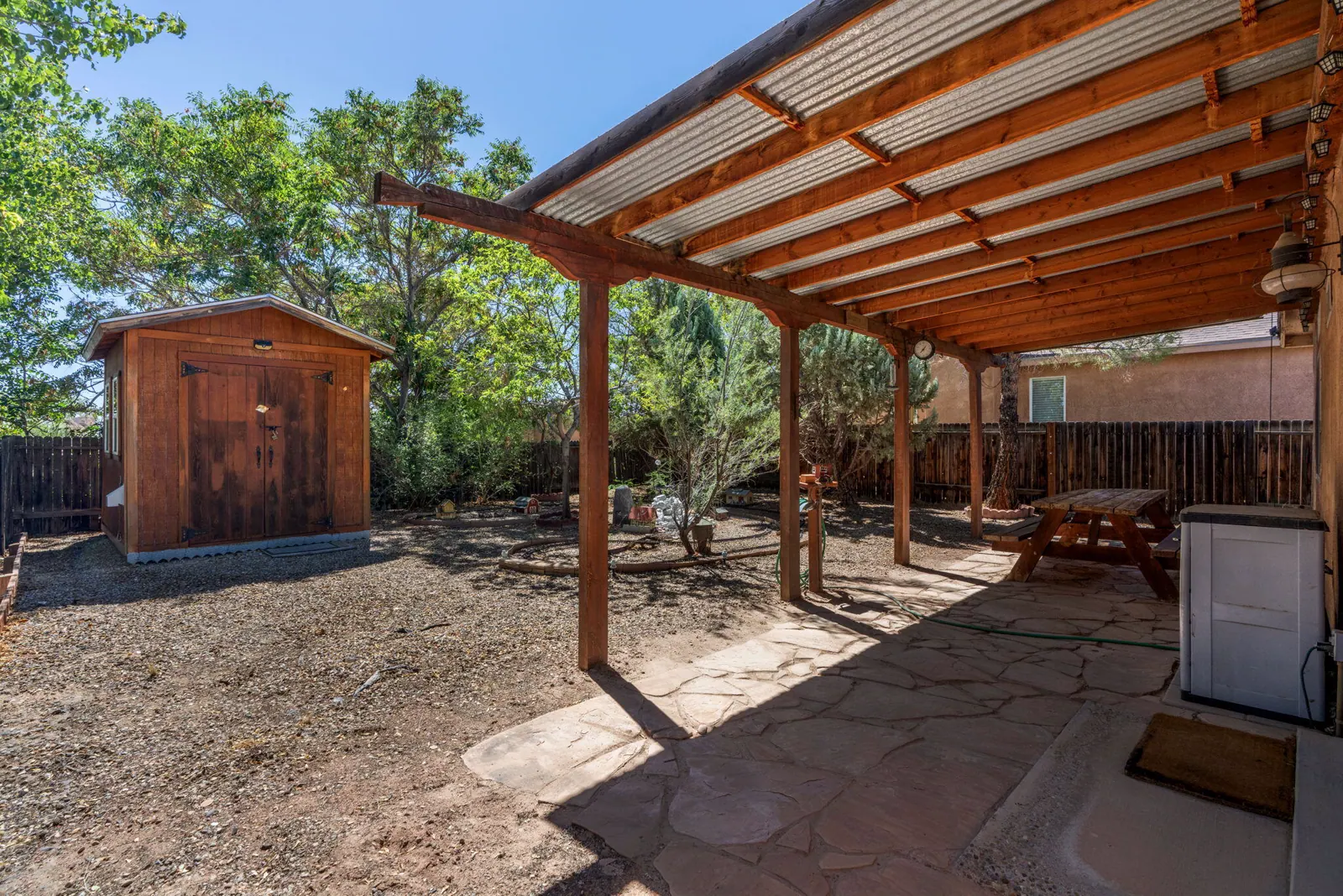 Covered patio and backyard storage shed at 6004 Cyonus Avenue NW