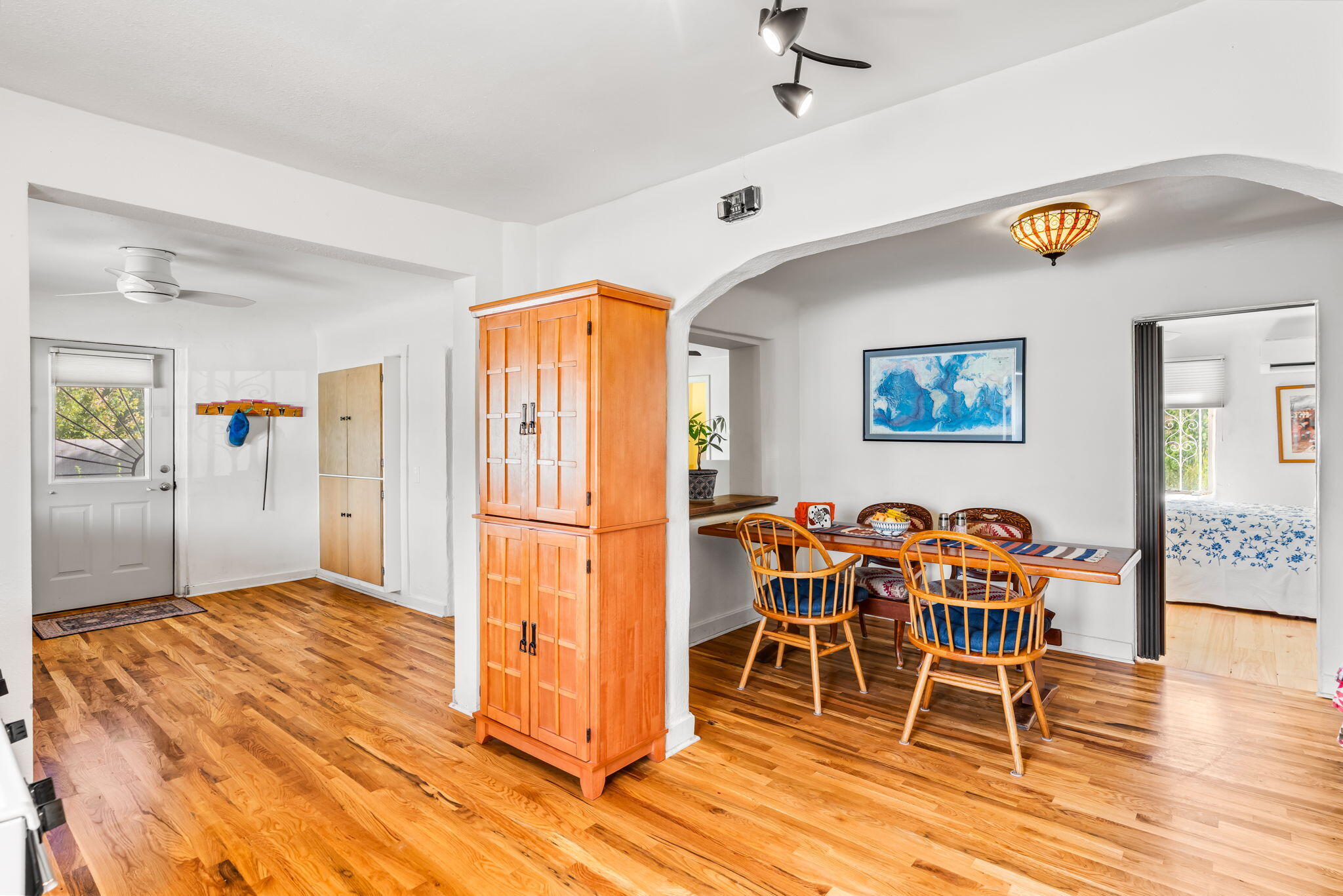 Dining area at 406 Atrisco Drive SW connected to the kitchen and adjacent rooms over continuous hardwood flooring