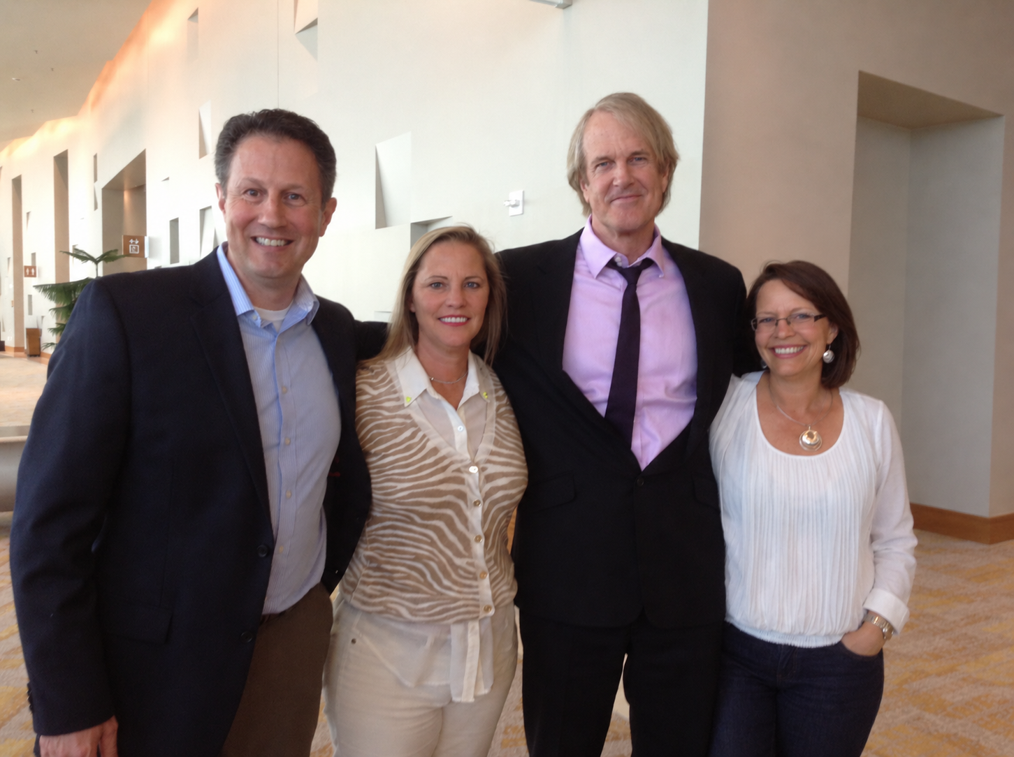 John Tesh with Tracy and Tego Venturi and a fourth attendee in an undated archive image.
