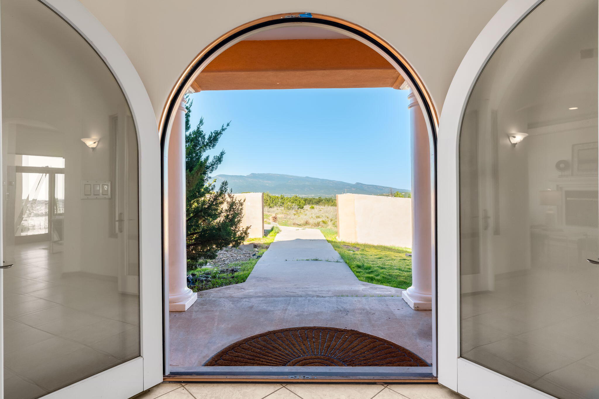 Arched front entry framing the mountain landscape at 31 Kramer Road